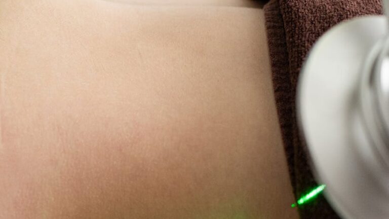 Close-up of a laser liposuction treatment in a contemporary clinic setting, emphasizing precision.